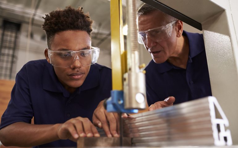 Mentor works with young entry level worker